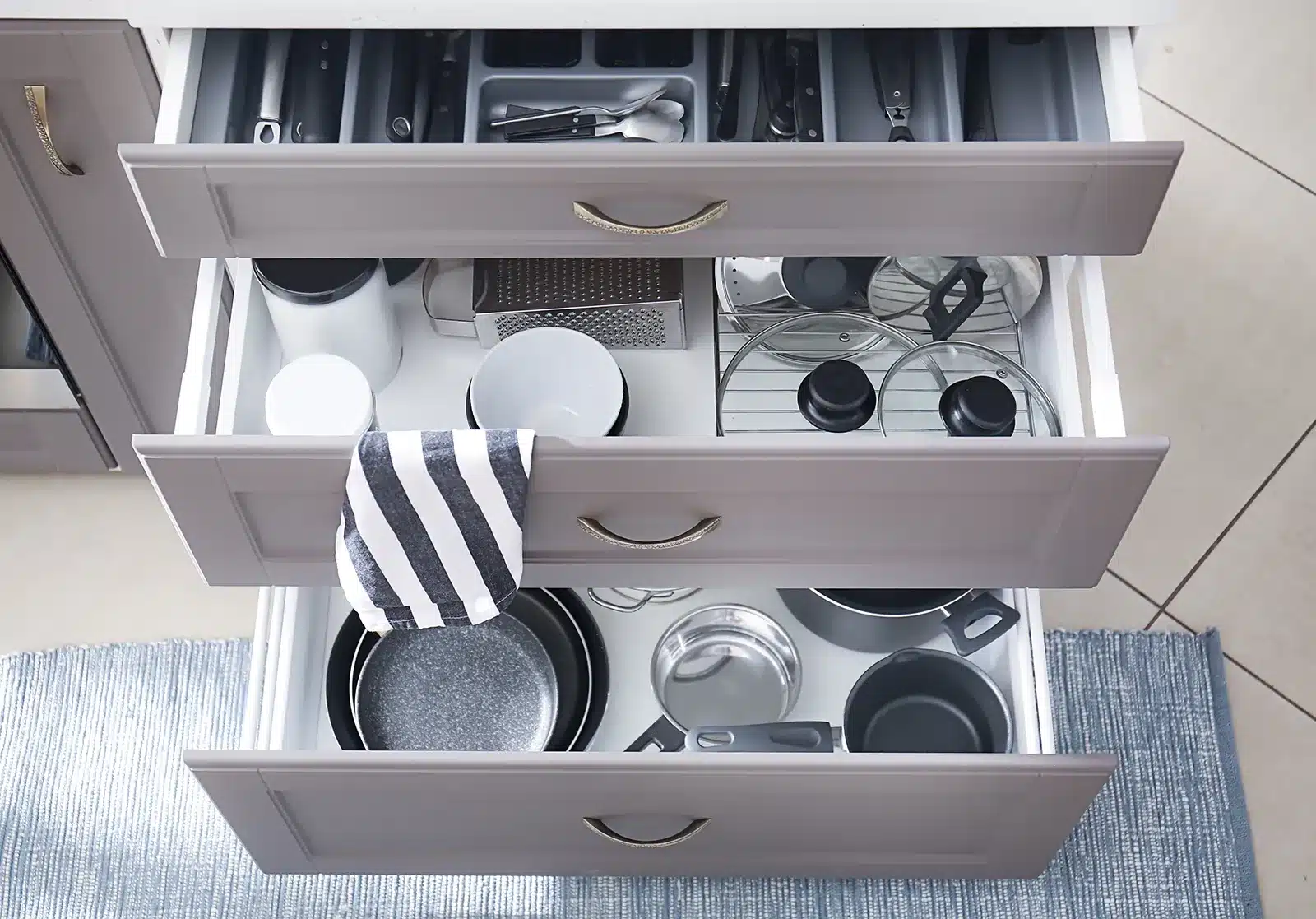 A kitchen showcasing deep drawer storage solutions, neatly organizing pots, pans, and utensils for easy access and efficient space utilization.