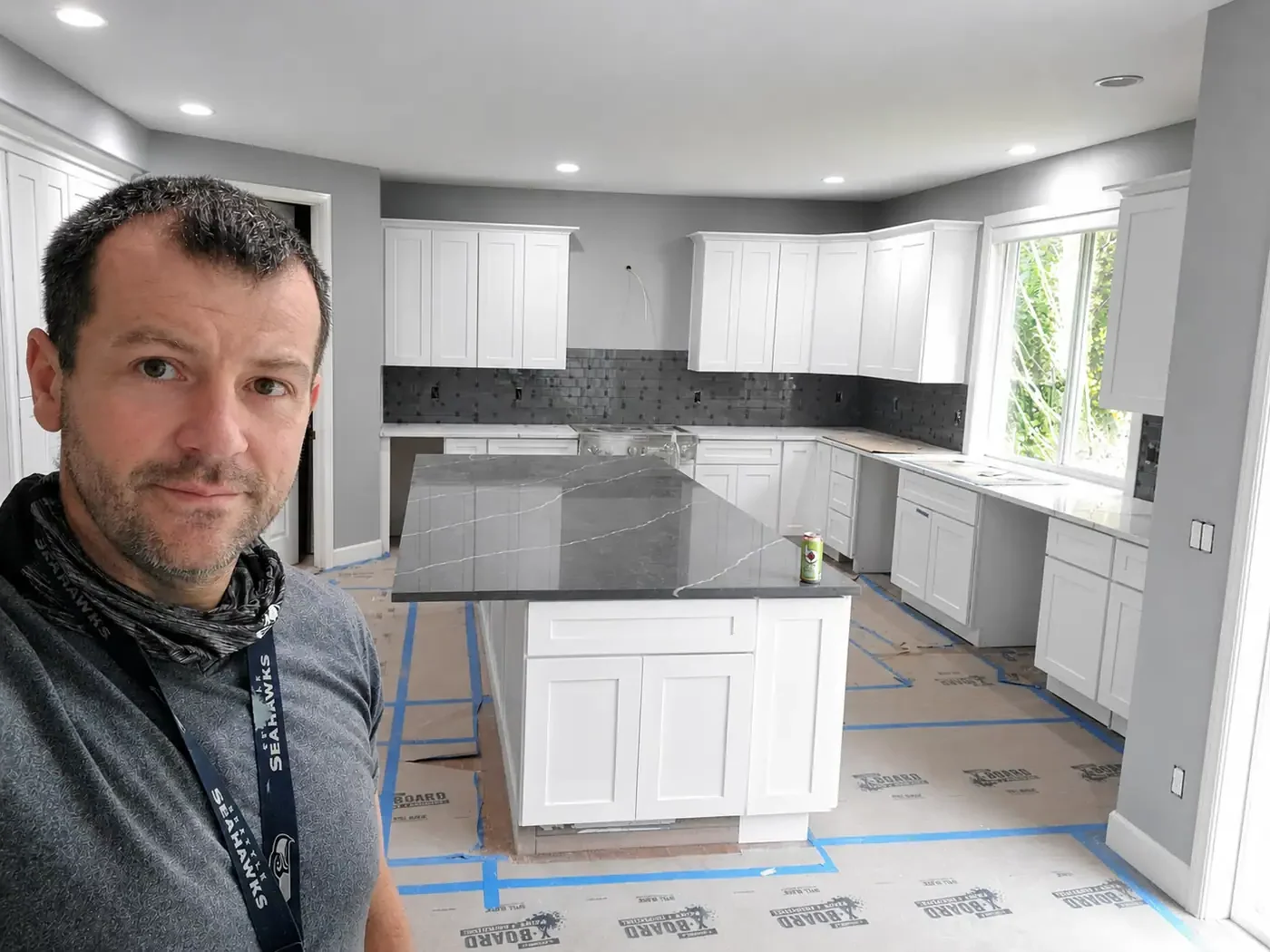 - project image Andriy Bezruchuk at the Redmond kitchen remodel during cabinet and quartz installation