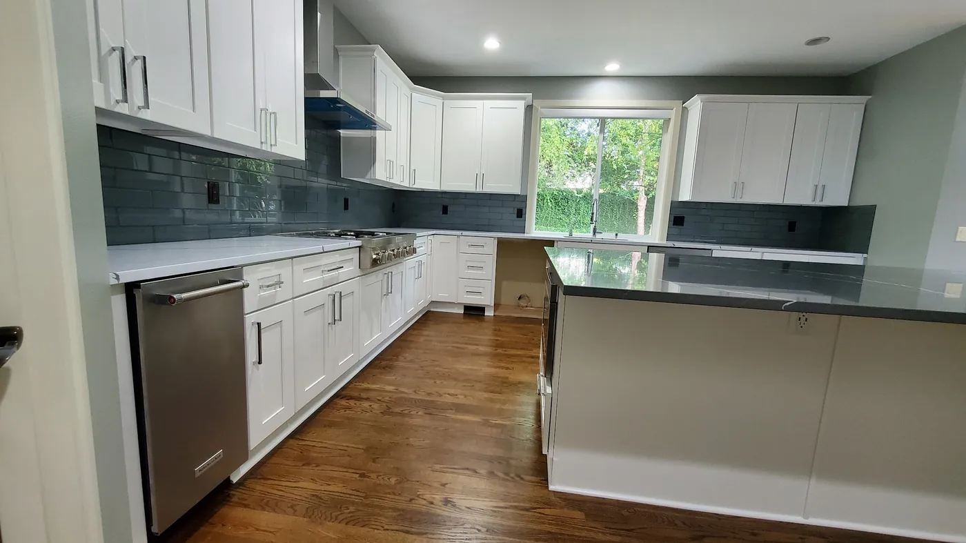 - project image Finished kitchen island view in the completed Redmond white shaker kitchen