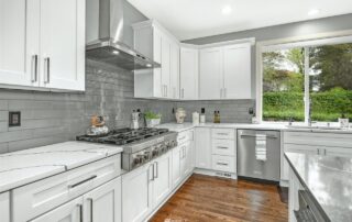 Remodeled Kitchen has Quartz countertops and backsplash with 3x12 Dunes Glass platinum Tile 