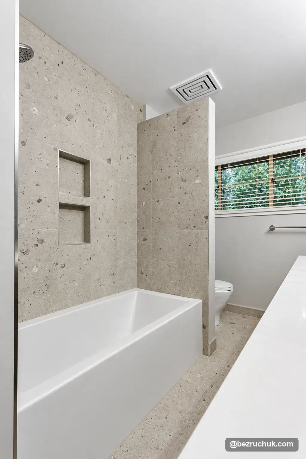 - project image Tiled bathtub and recessed niche beside a window in the Mercer Island bathroom
