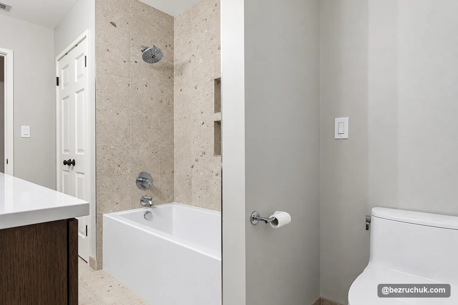 - project image Mercer Island bathroom with a tiled bathtub surround, toilet and dark wood vanity
