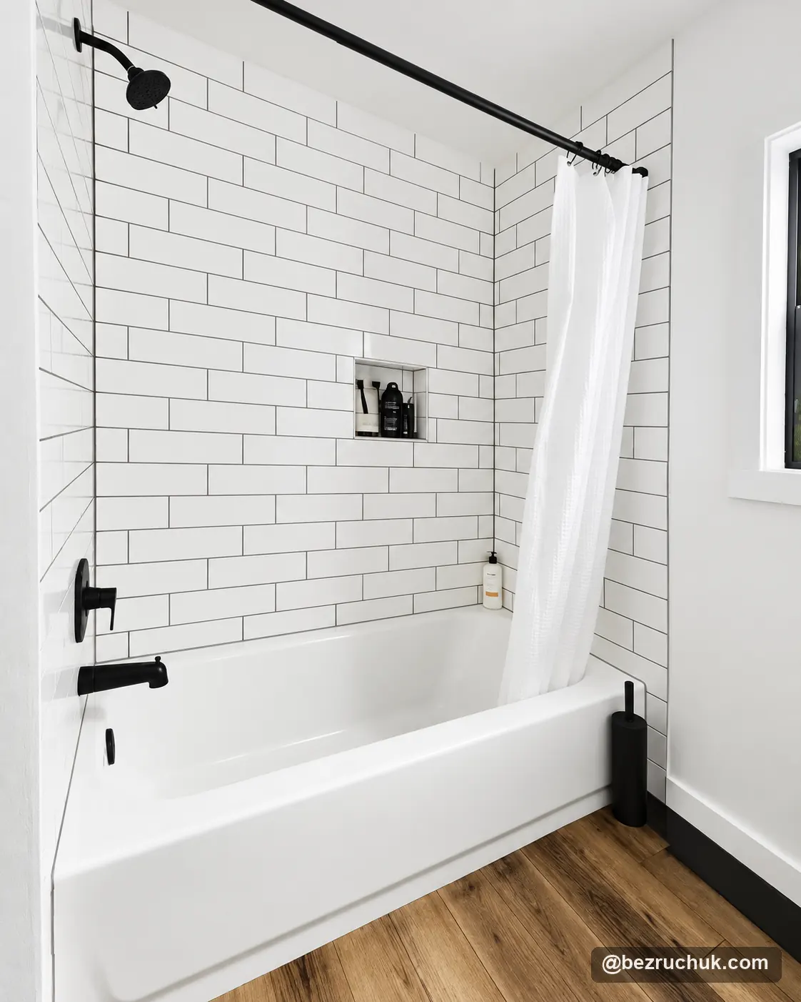 - project image White subway tile tub surround with dark grout, recessed niche and black shower fixtures