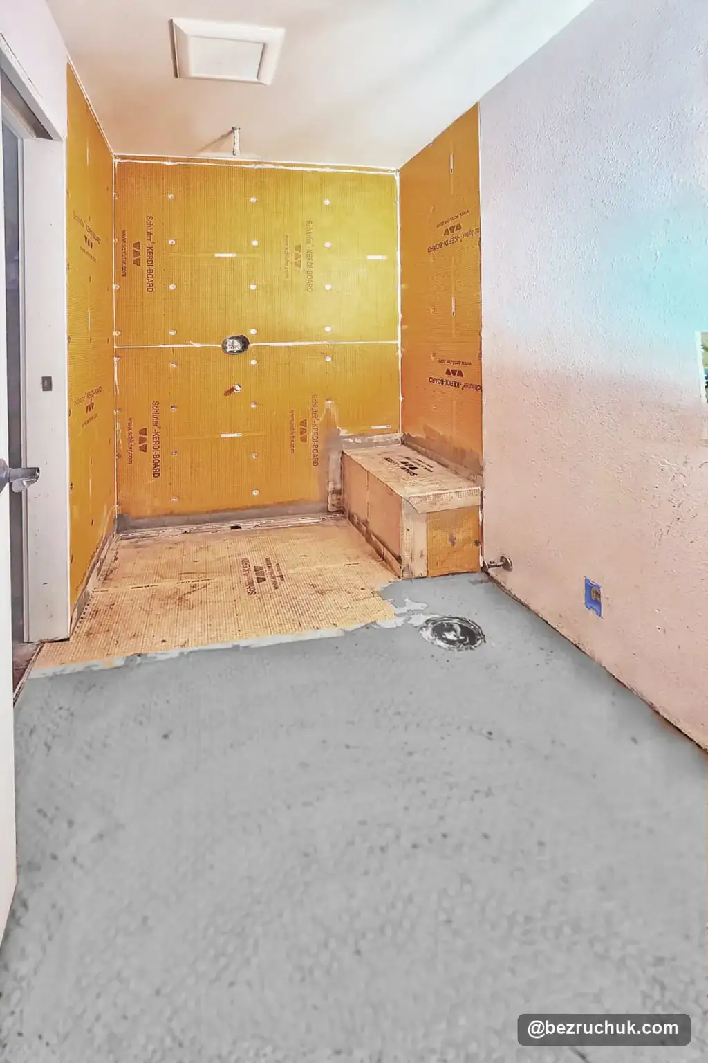- project image KERDI sheet covering on the shower floor and gray main-floor preparation before tile
