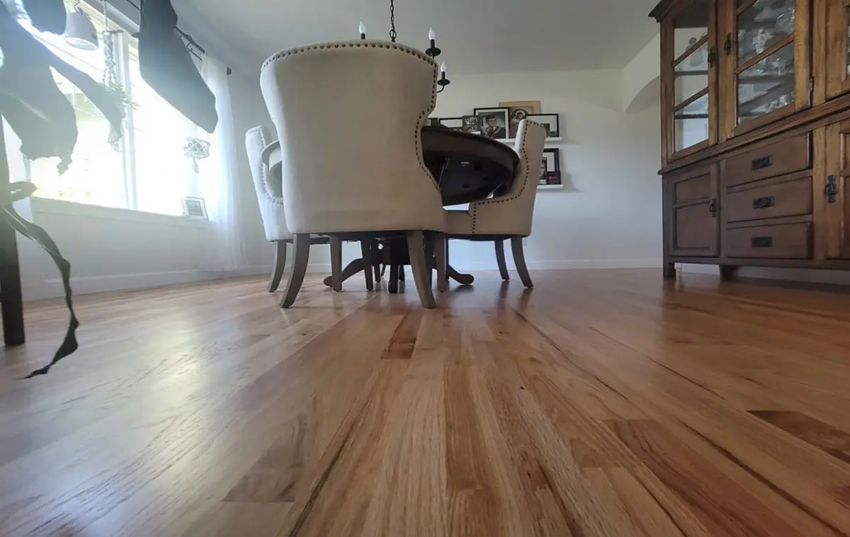 Restored hardwood flooring in the Puyallup dining room after water damage repair