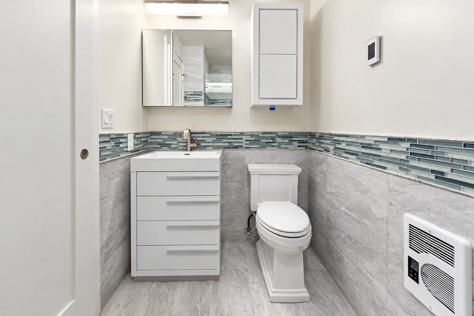 Tiny bathroom renovation in Carnation with white vanity drawers and wall storage
