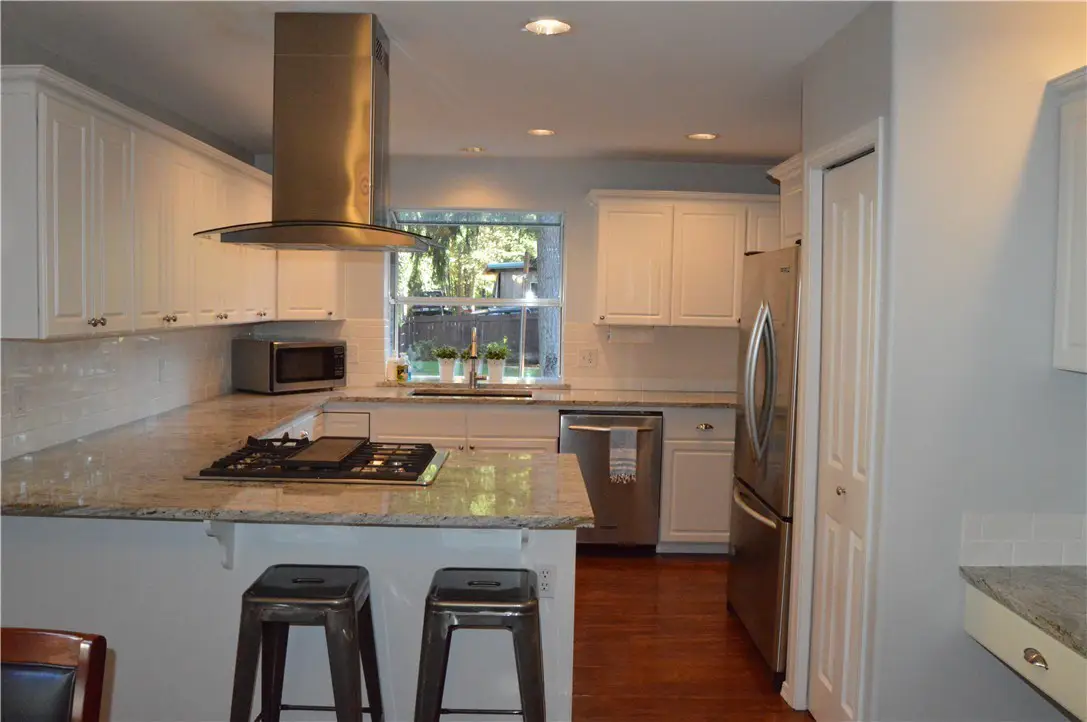 Before kitchen remodeling project Graham WA with outdated cabinets and granite counters.