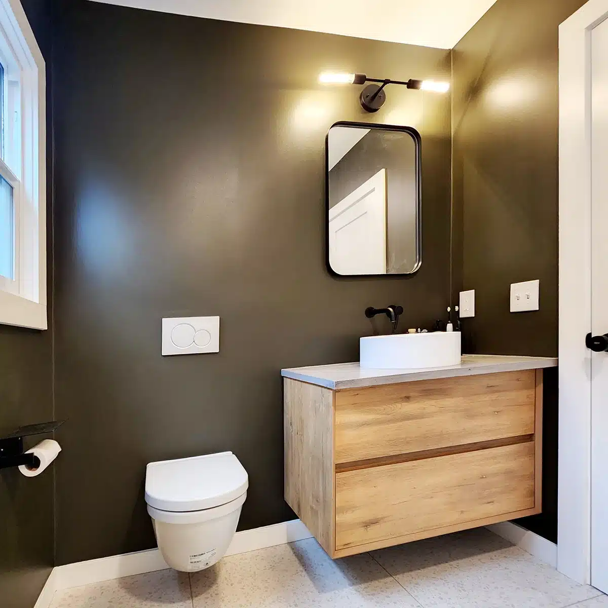 Elegant bathroom with dark walls, wooden vanity, and modern fixtures.