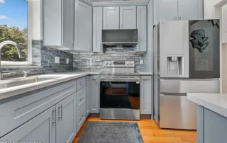 Remodeled kitchen in Puyallup with over-the-range microwave and backsplash design.