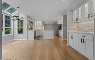 bright open-concept kitchen and dining remodel with white shaker cabinets and hardwood flooring in Issaquah