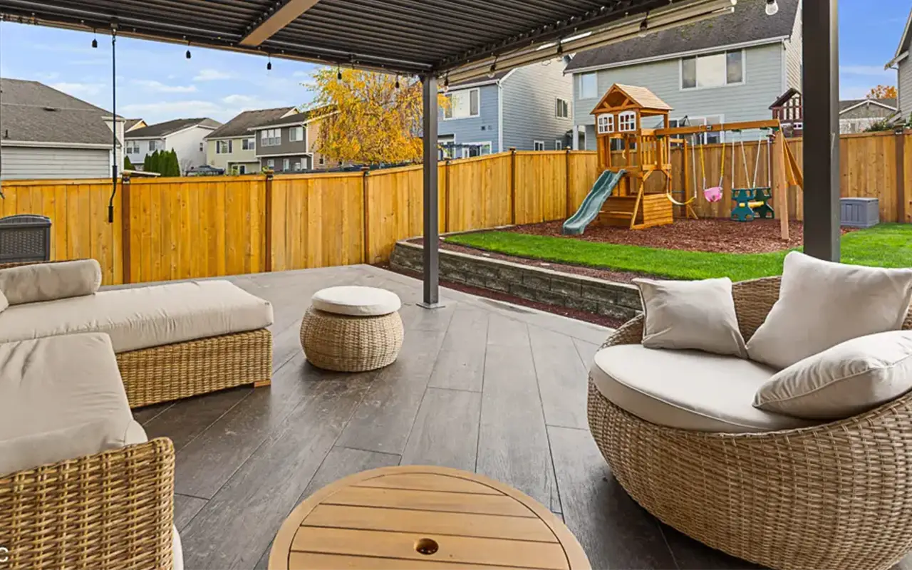 - project image Outdoor living area after full home renovation with covered patio and seating