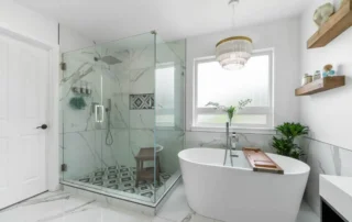 - project image Bathroom remodel after water damage featuring freestanding tub, Schluter waterproofed shower, and modern tile finishes