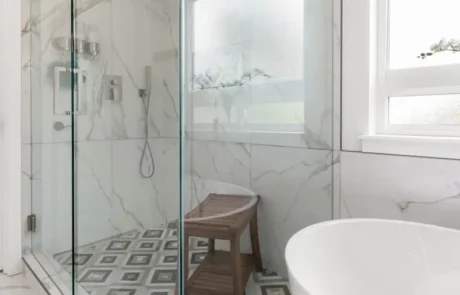 Shower and Tub Spatial Layout Glass shower positioned next to freestanding tub in an open bathroom layout