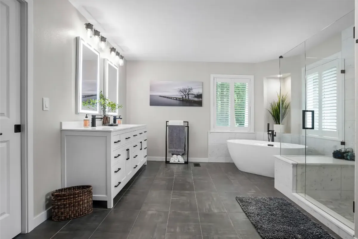 Modern master bathroom after renovation in Canton Ohio with freestanding tub, walk-in shower, and double vanity