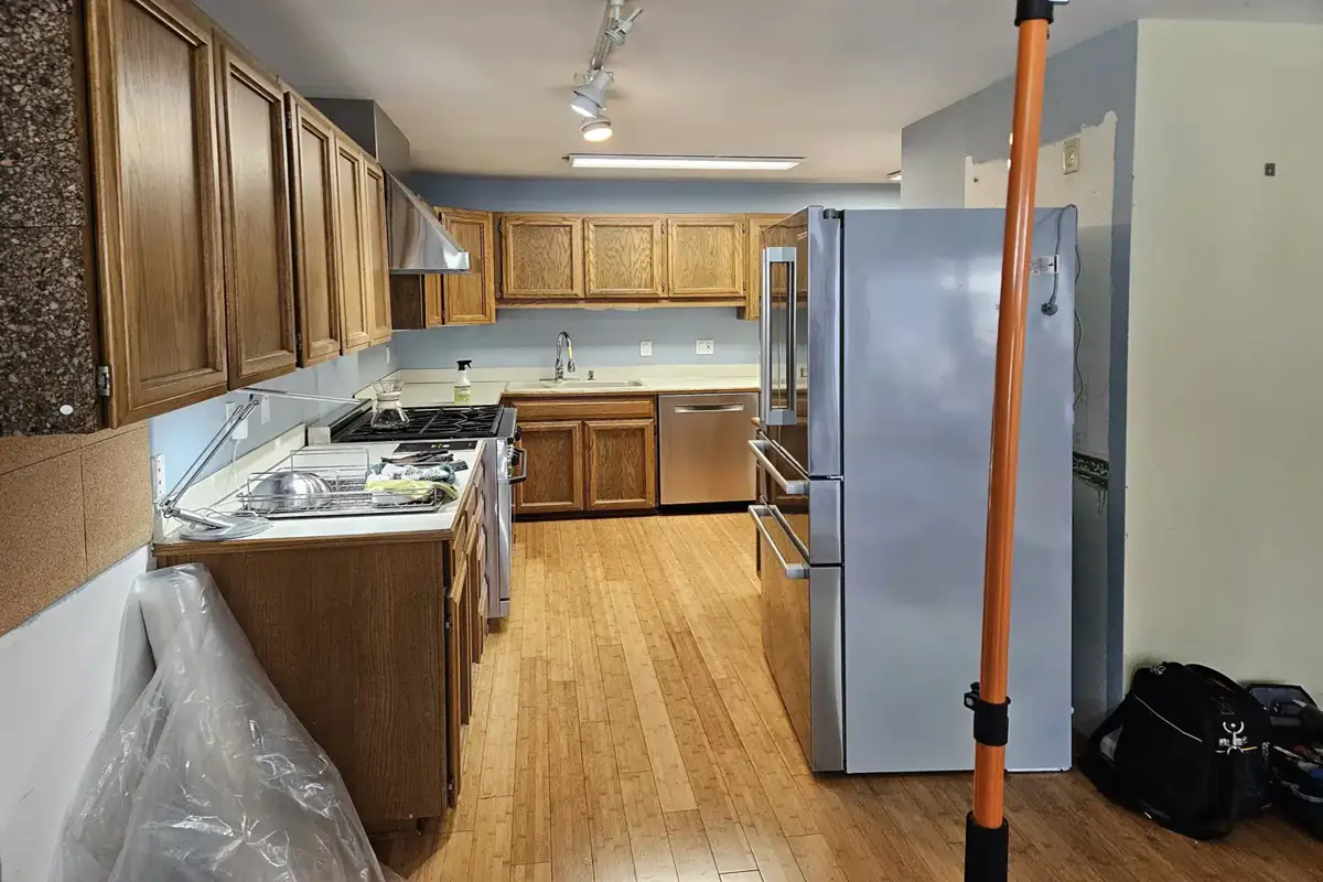 outdated kitchen with old wood cabinets narrow layout and limited workspace before renovation
