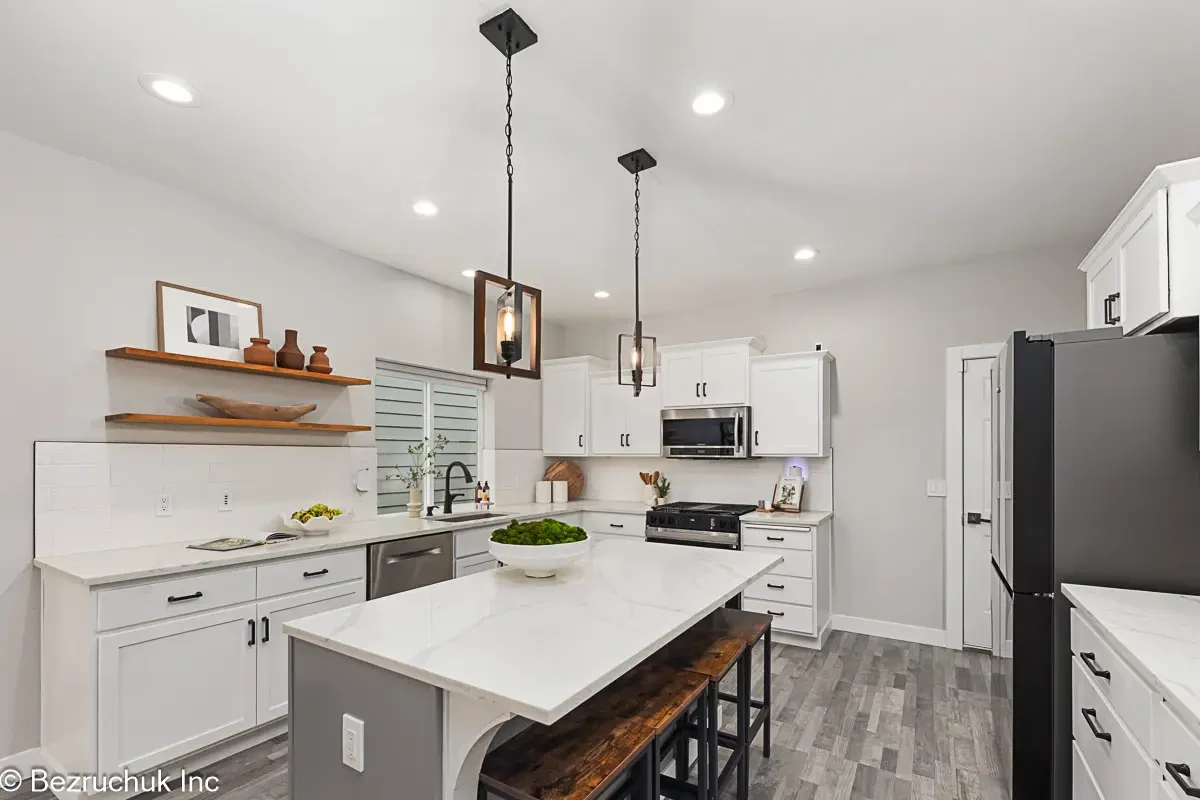 Akron Home Renovation Modern White Kitchen Example Kitchen renovation example with white cabinetry, island, pendant lighting, and open modern layout