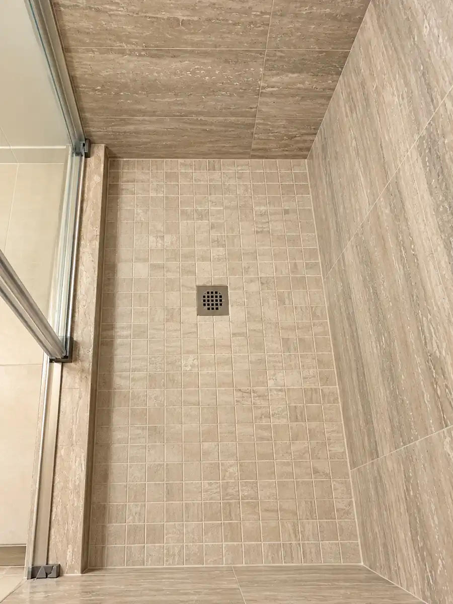 - project image Small square mosaic shower floor with a square drain and tiled threshold