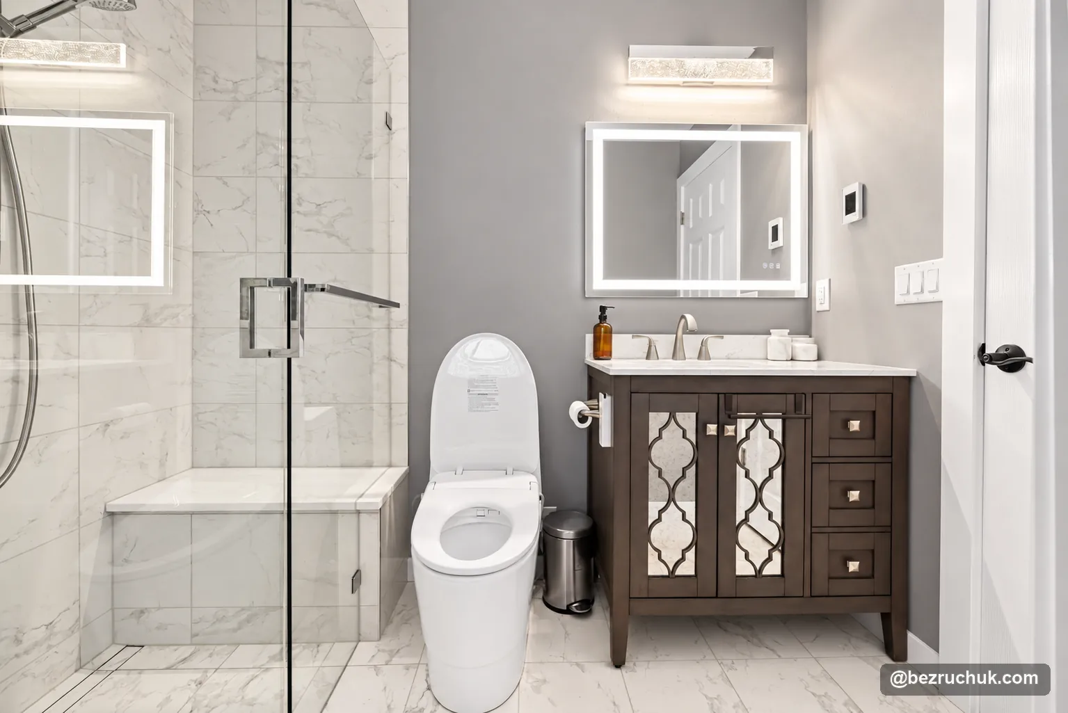 Curbless shower entry in Ames Lake with clear glass, a tiled bench and the retained dark vanity