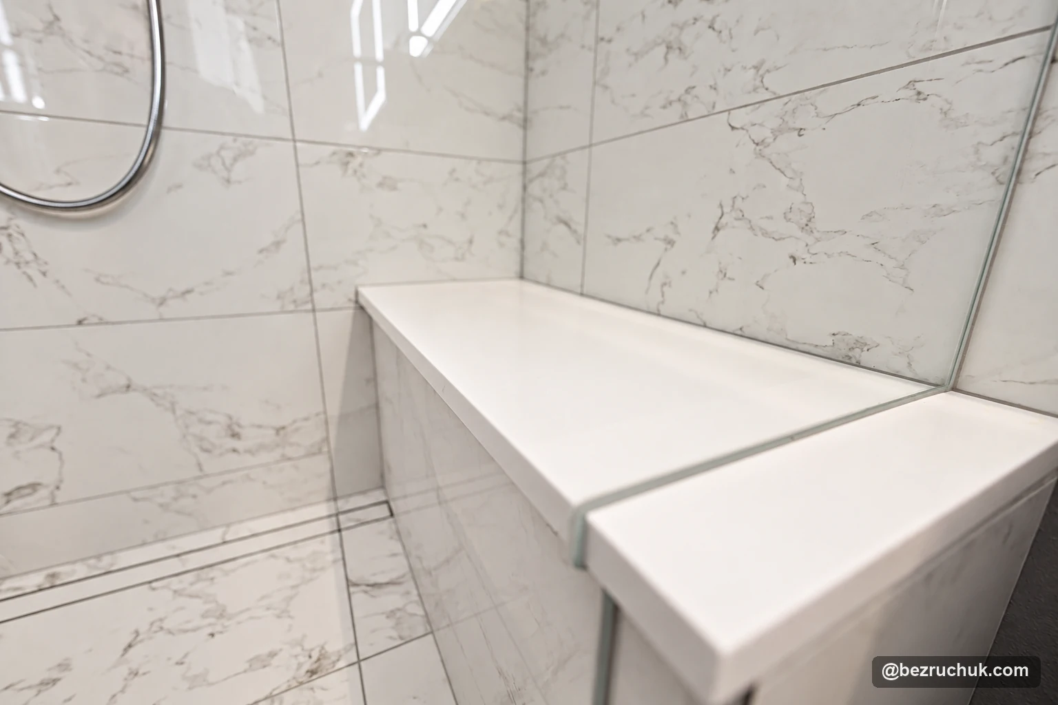 - project image Built-in tiled shower bench with a light top beside the glass panel