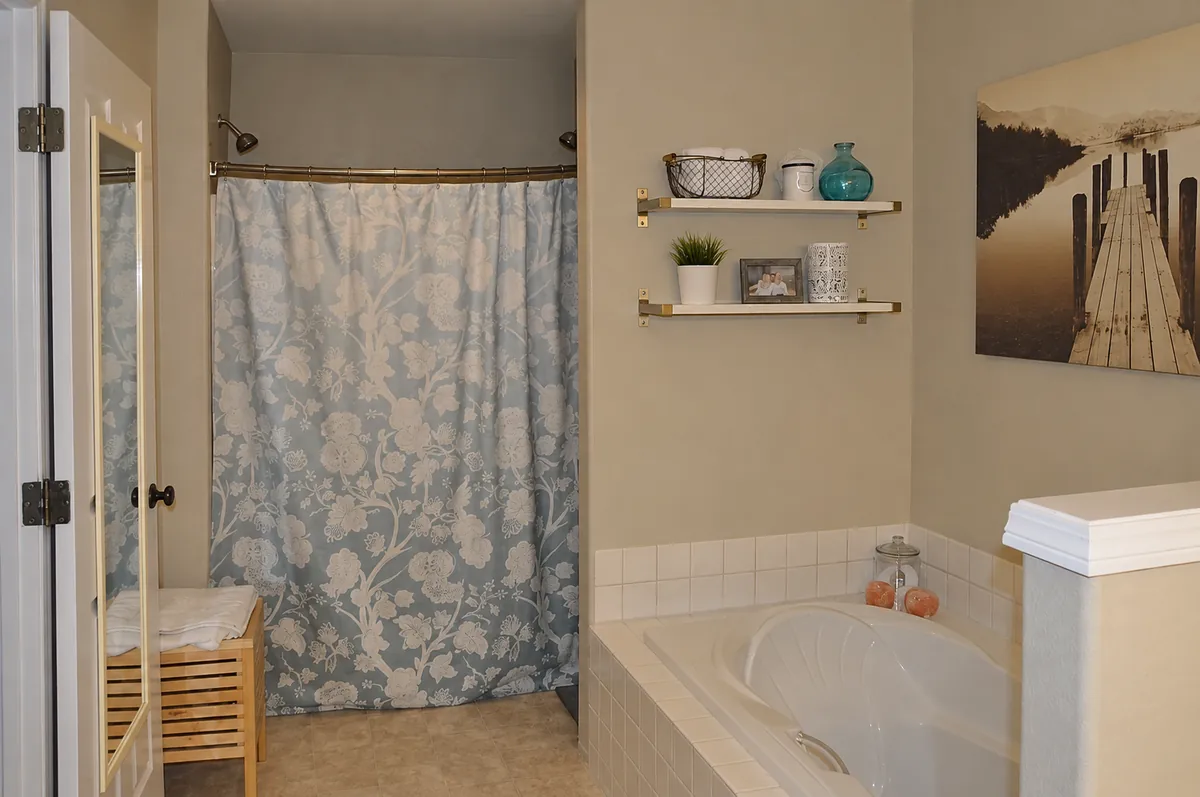 - project image Original Graham bathroom with a built-in tub, white tiled surround and shower curtain