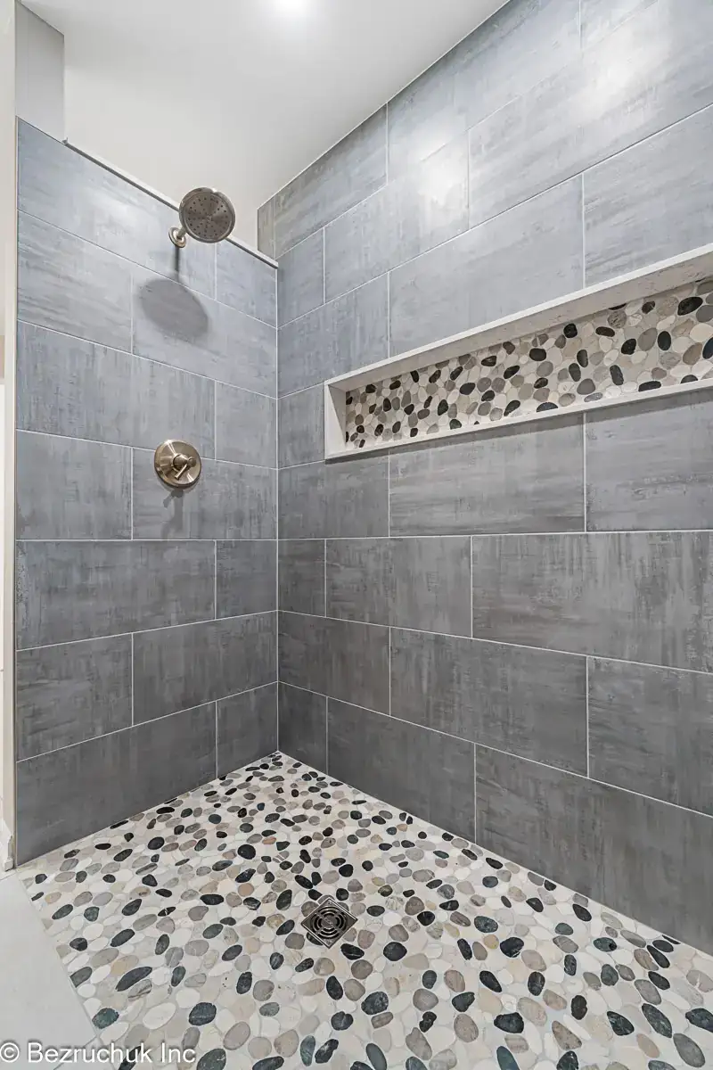 - project image Pebble mosaic shower niche with quartz sides in gray wall tile