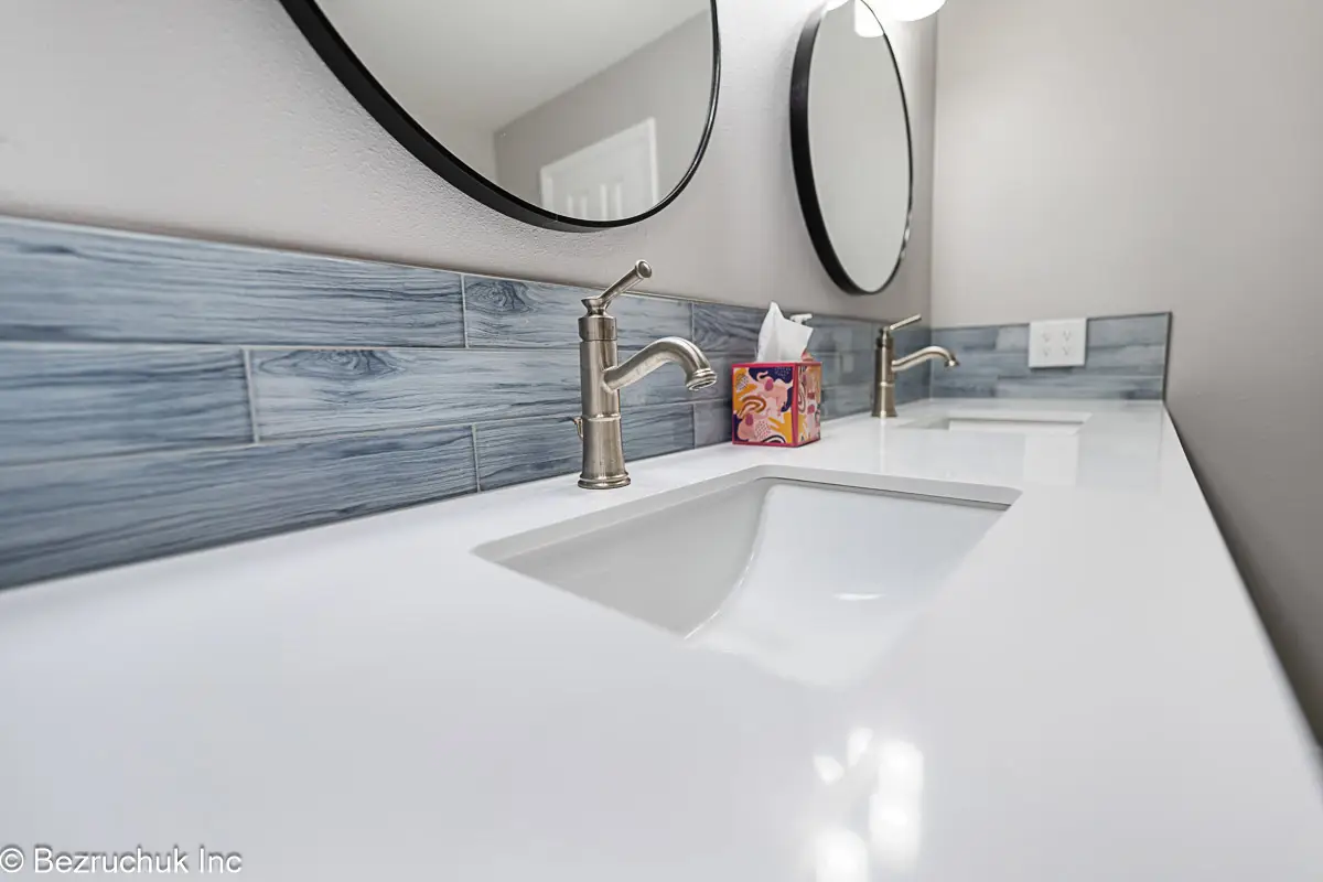 - project image Vanity faucet and rectangular sink in a quartz top with blue-gray backsplash tile