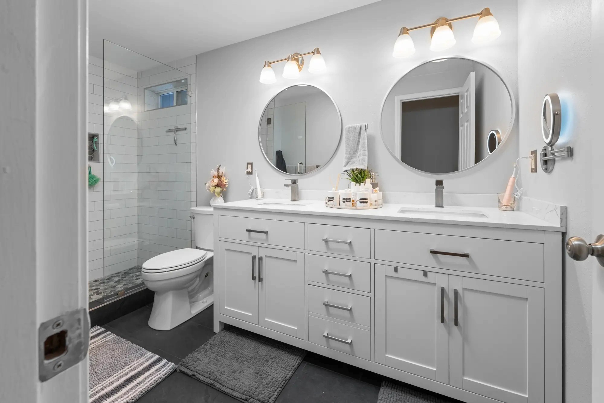 Entry view of the glass shower and double vanity in a Graham WA guest bathroom