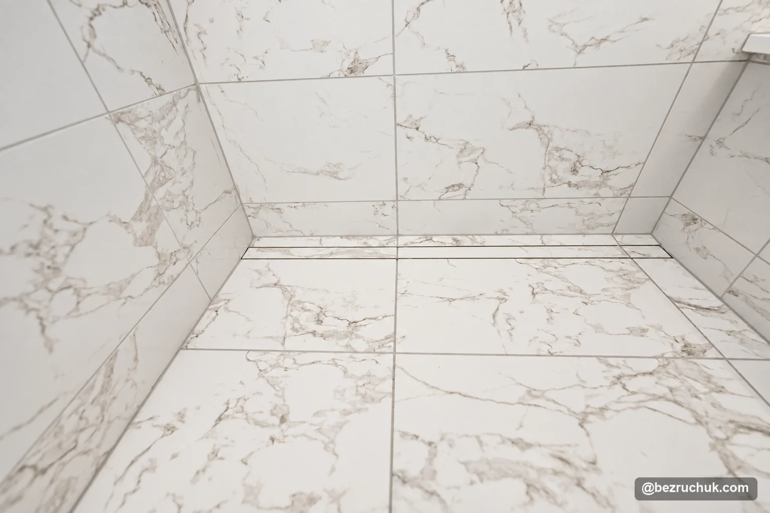 - project image Linear shower drain along the wall of the tiled curbless shower floor