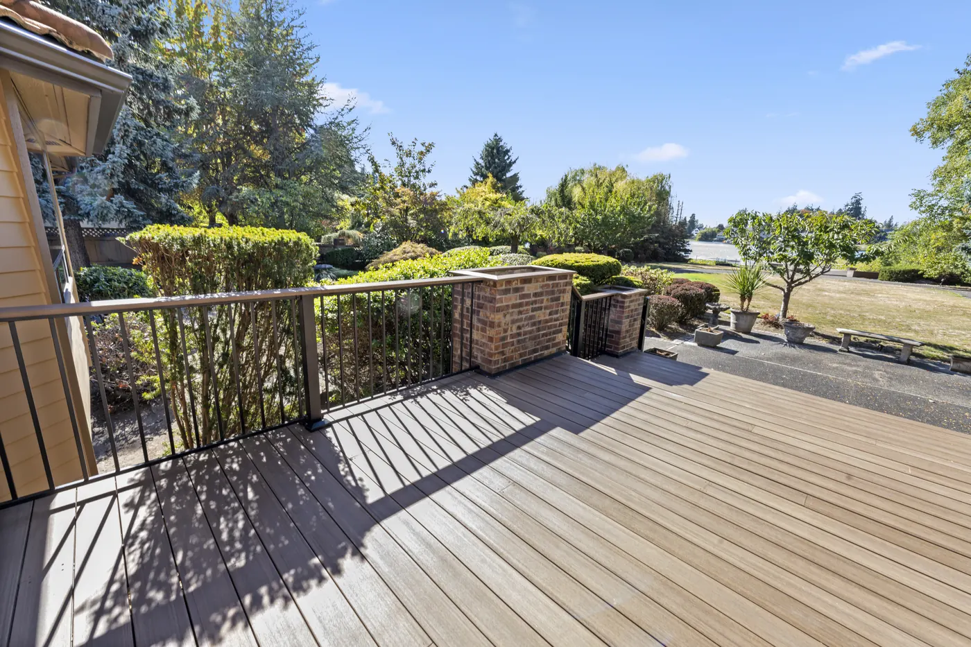 - project image Black railing sections between brick columns at the Edgewood deck.