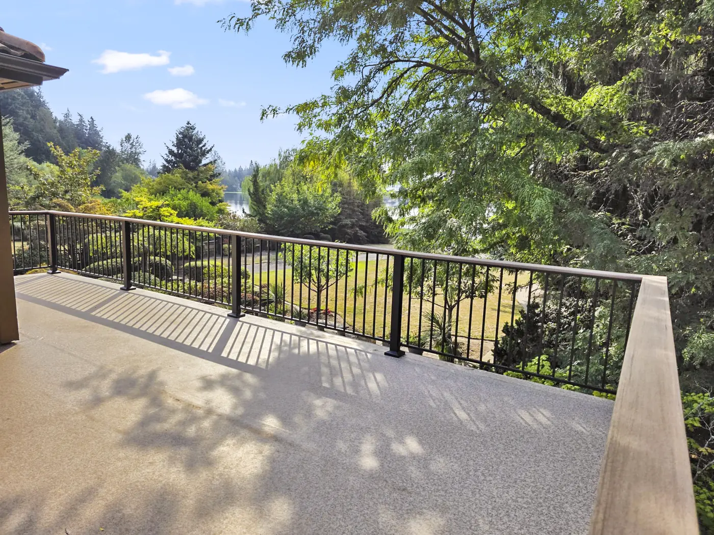 - project image Upper balcony with black railing at the Edgewood home.