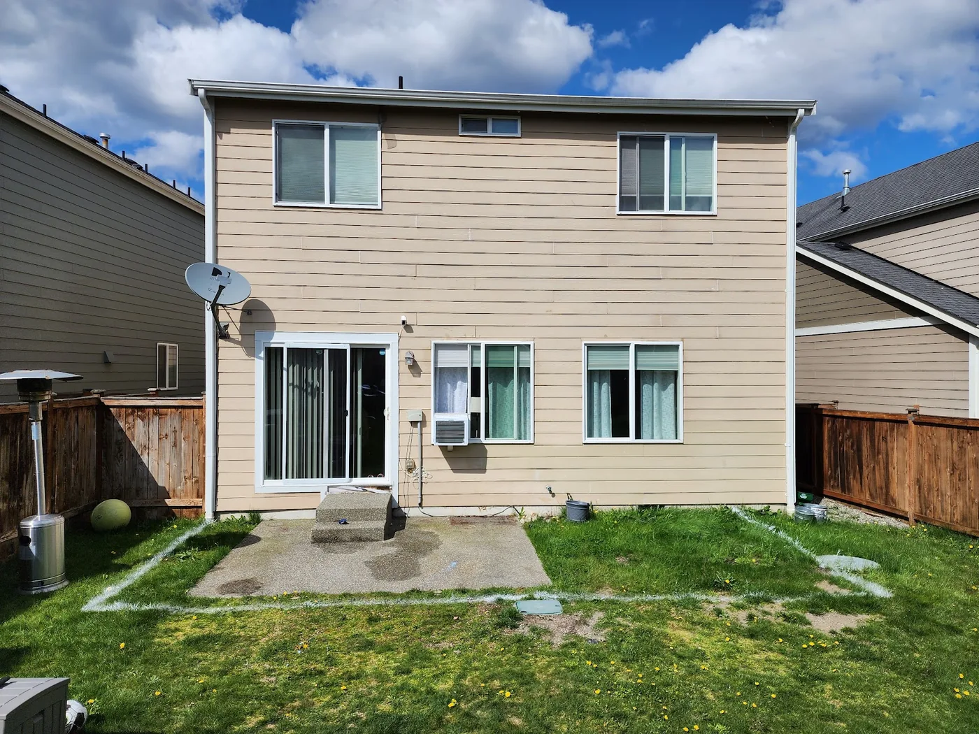 - project image Original small concrete landing and patchy lawn at the back of the Lipoma Firs house.