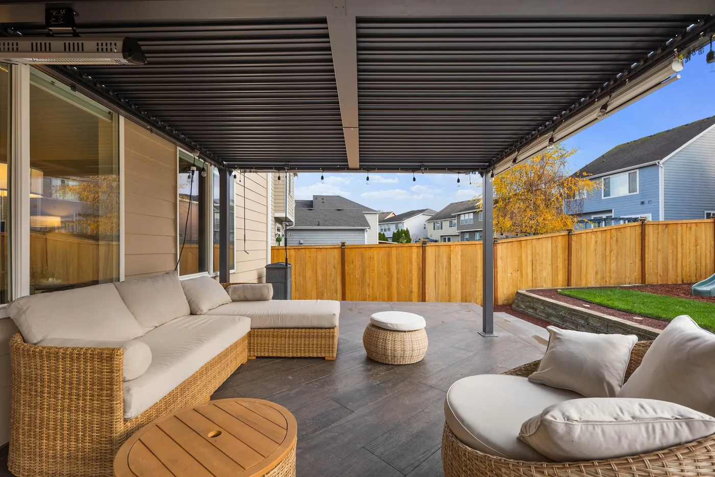 - project image Seating beneath the pergola with the porcelain deck surface visible in the foreground.